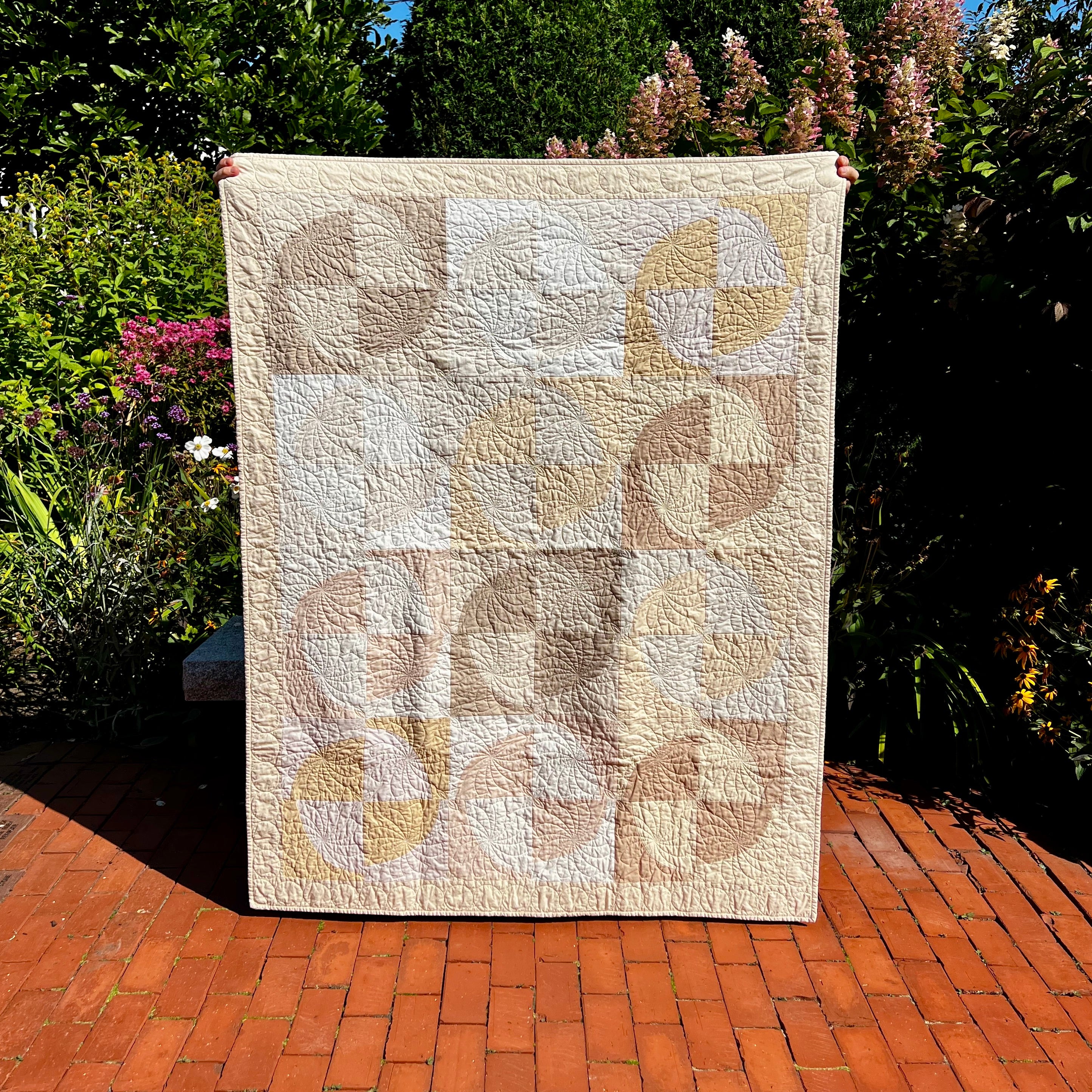 pale moons throw quilt- cropped circle pattern - muted tones