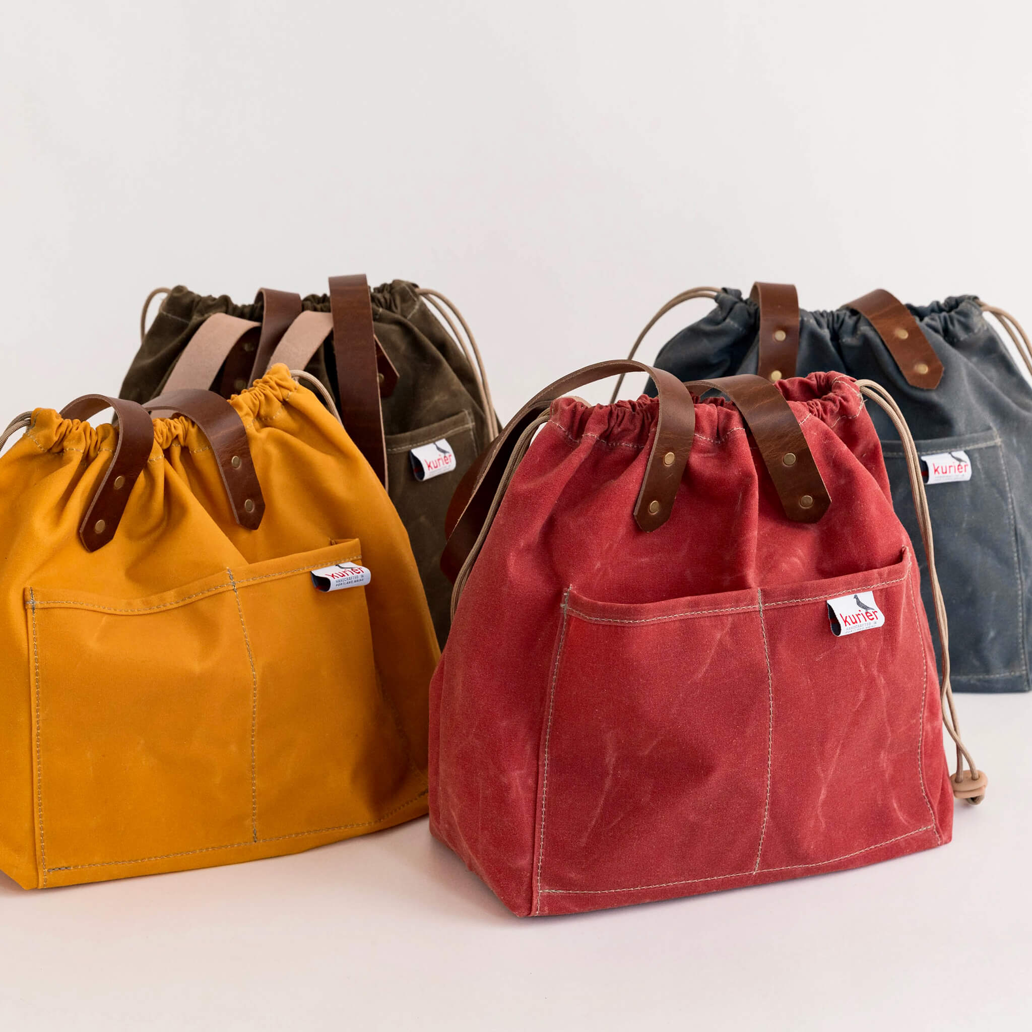 waxed canvas town tote - drawstring travel bag - handmade leather - group view